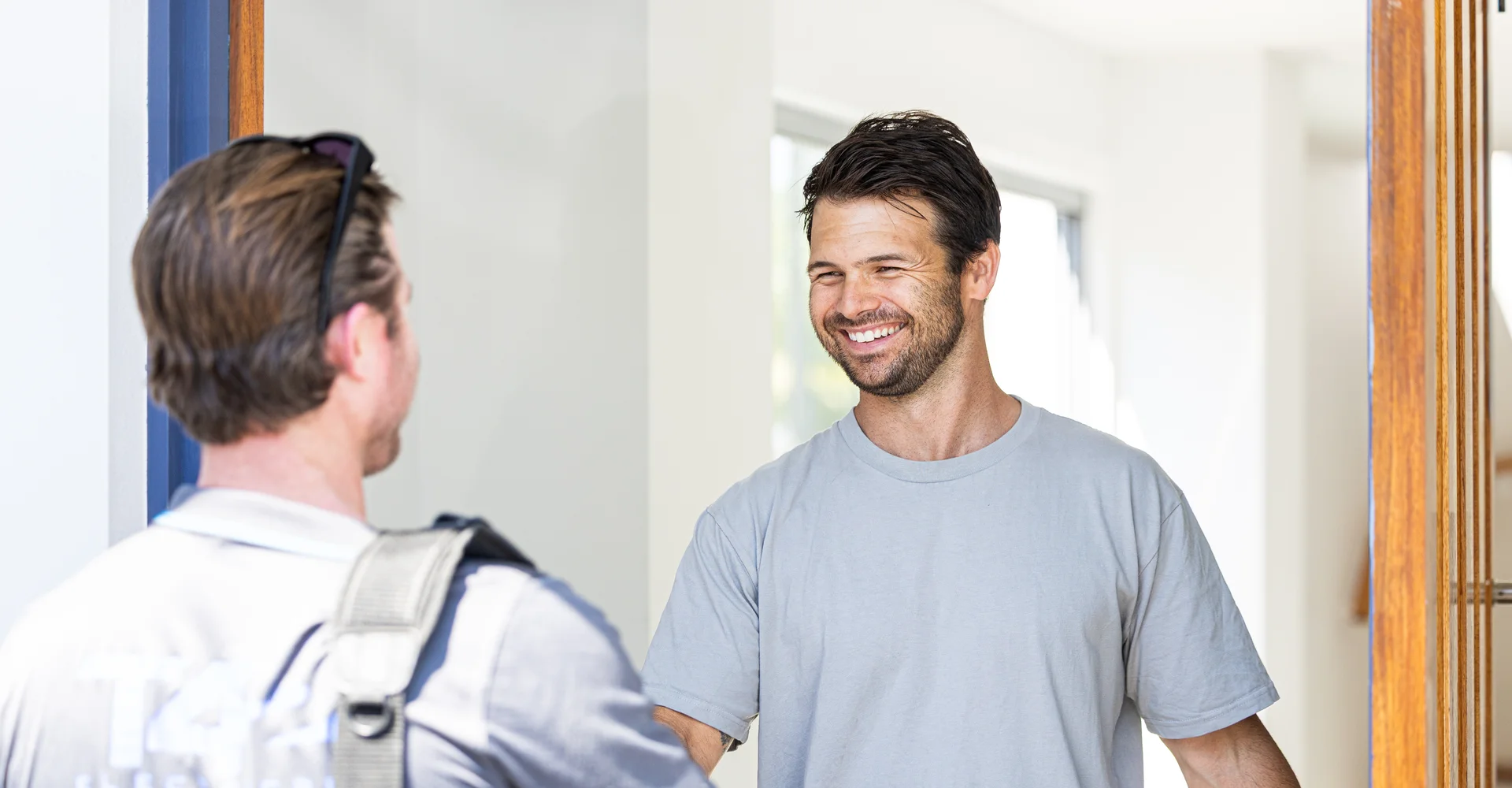Licensed local electrician greeting a customer at the door